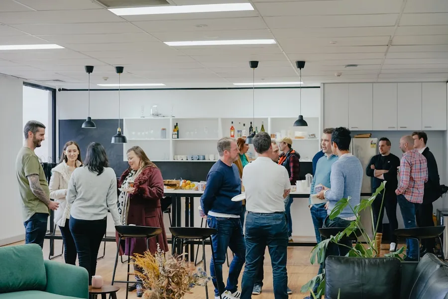 Attendees talking over coffee in an event lounge
